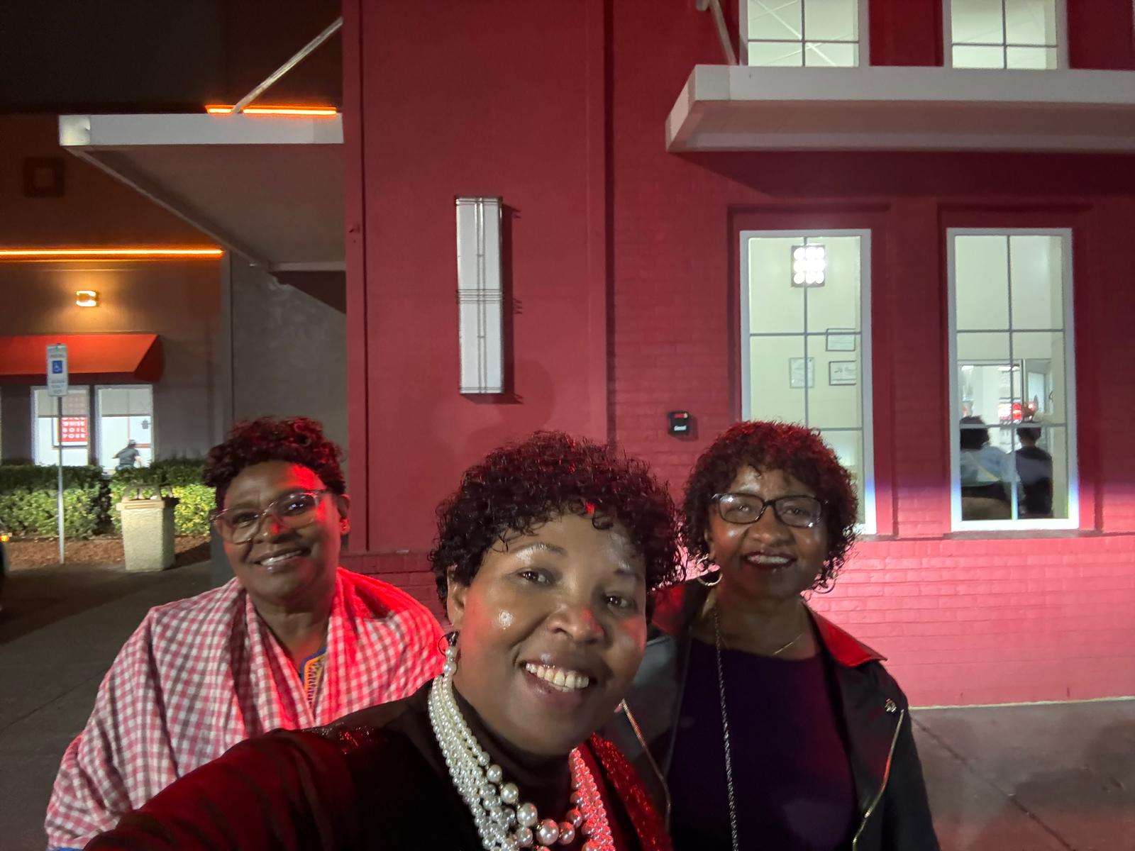 Three community friends outside a restaurant