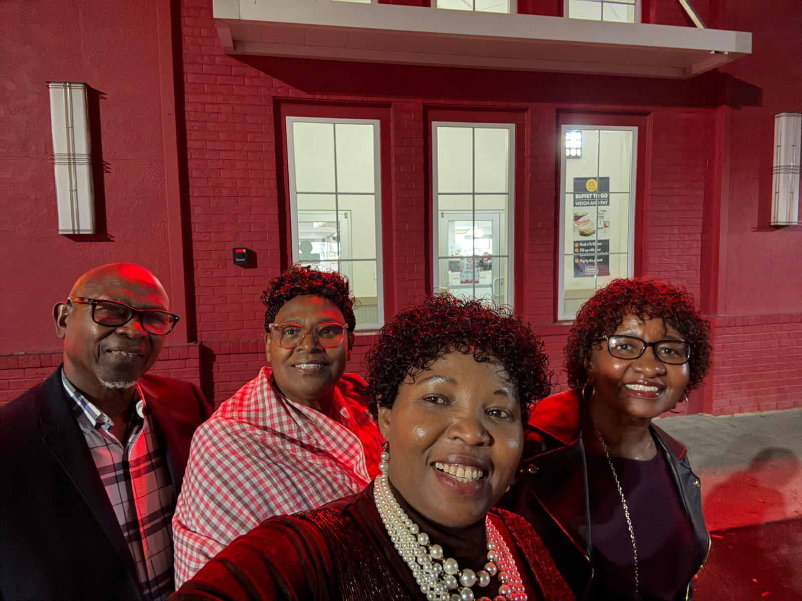 Four ADADO community members sharing an evening outside a restaurant