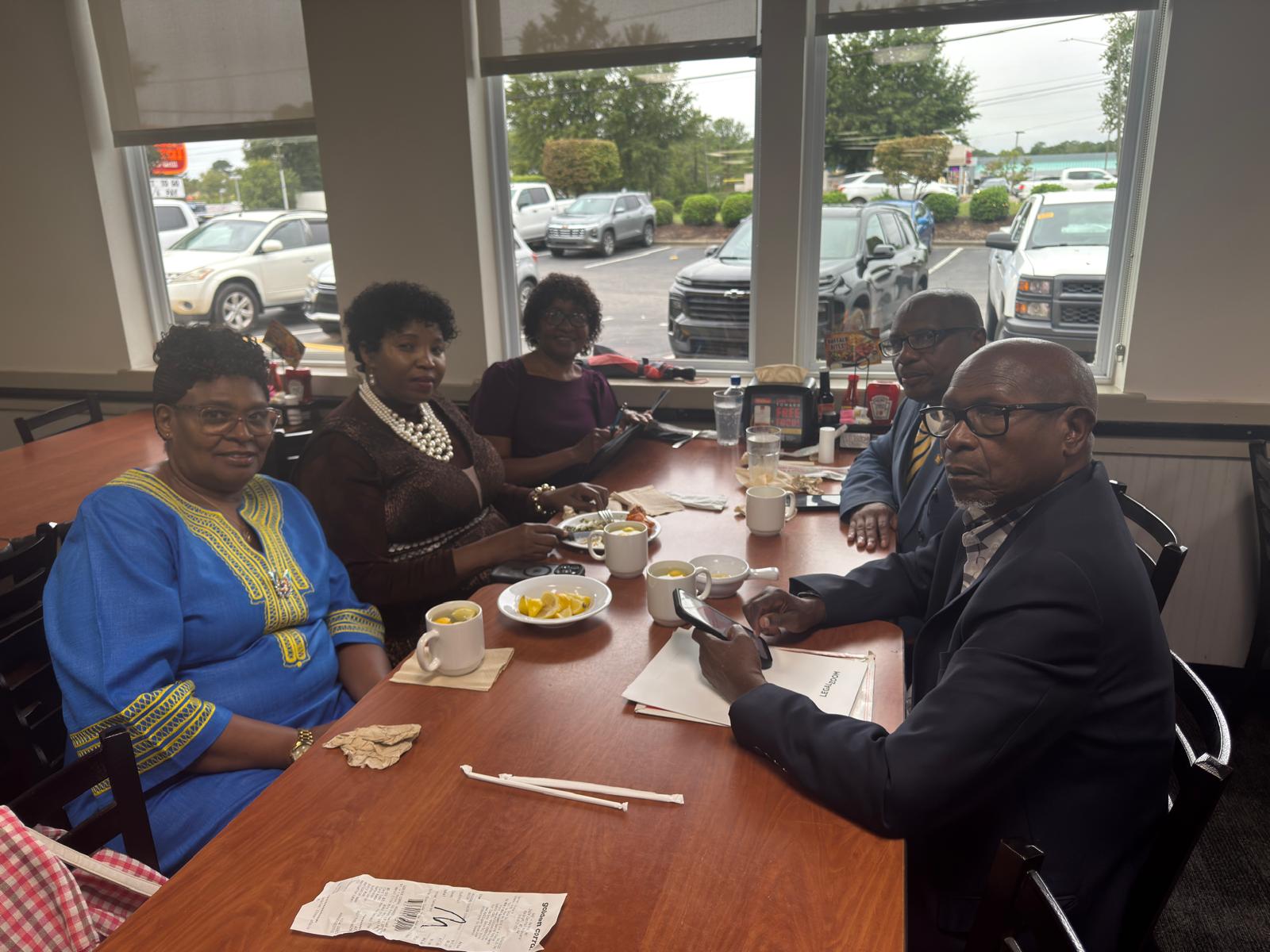 ADADO team members meeting around a table